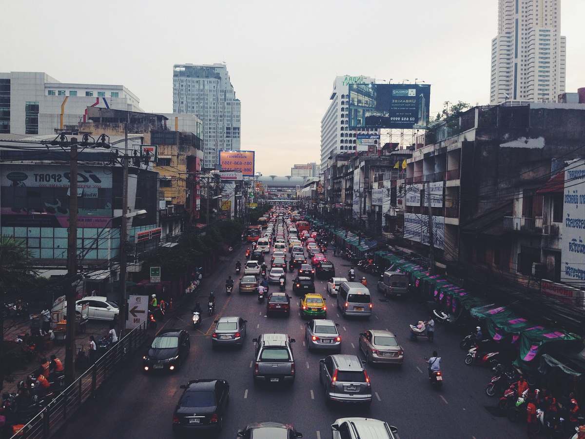 traffic jam assorted cars on asphalt road beside buildings road
